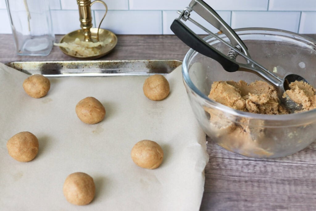 fresh milled maple brown sugar cookie dough rolled into balls on a baking sheet