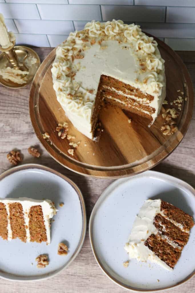 freshly milled carrot cake with two slices cut out on plates