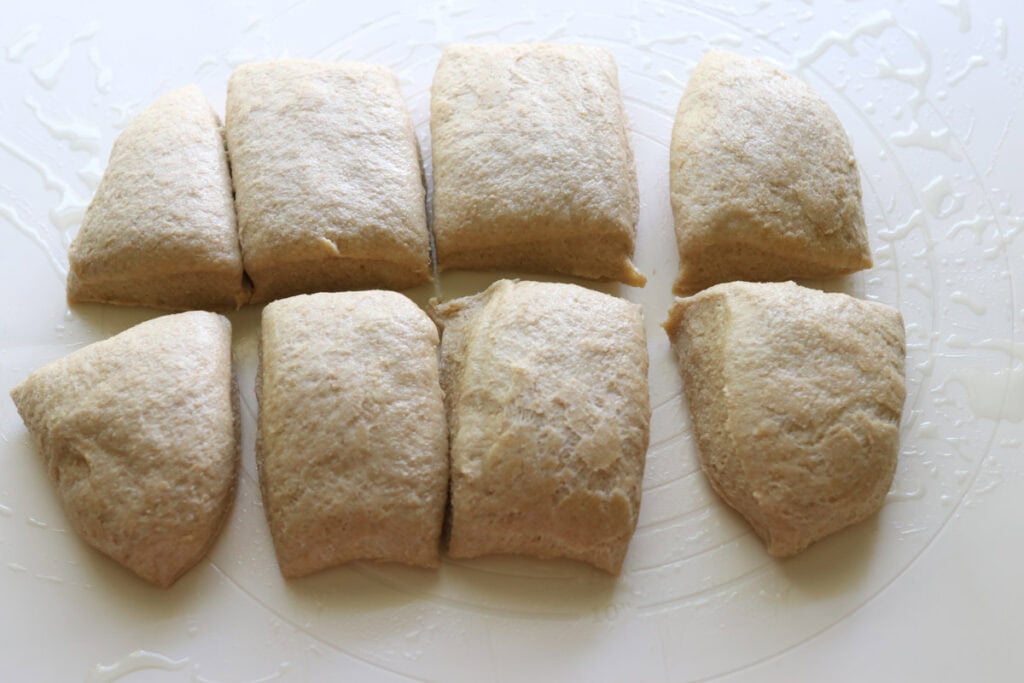 freshly milled fluffy brioche dough that has been cut into 10 pieces