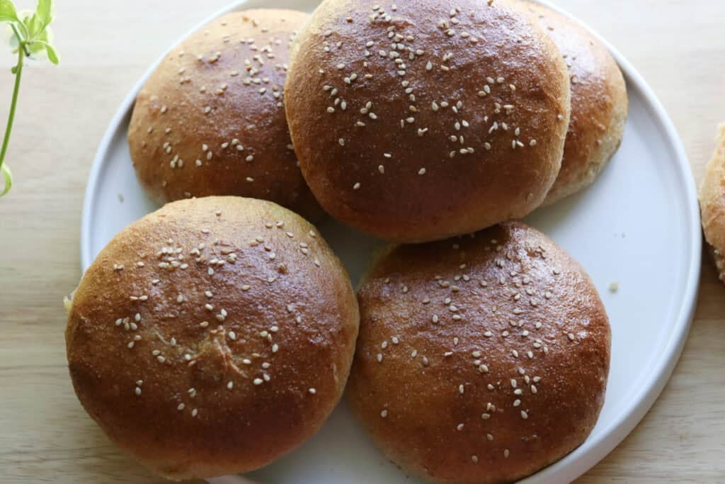 freshly milled brioche burger buns on a white plate