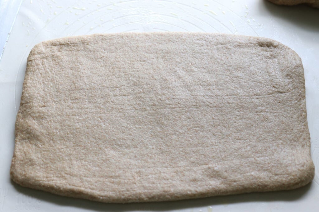 cinnamon swirl dough rolled out into a rectangle