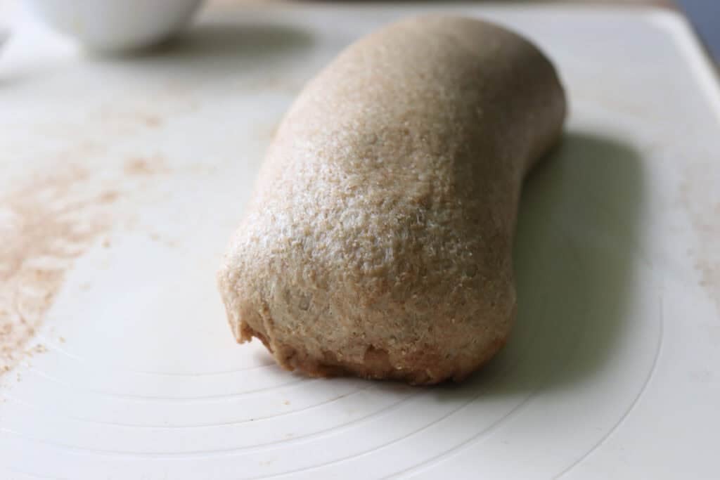 fresh milled cinnamon swirl dough with the edges tucked under