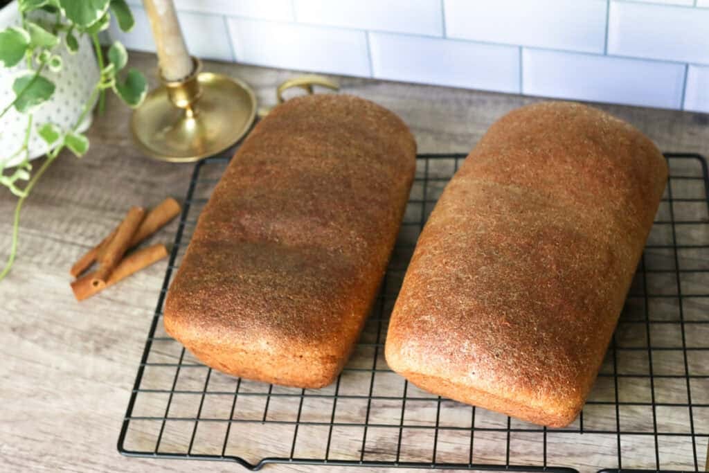 two fresh milled cinnamon swirl loaves on a cooling rack