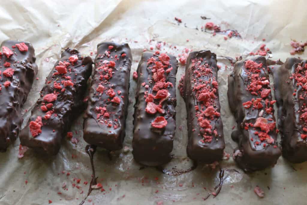 chocolate covered strawberries & cream coconut bars with freeze-dried strawberries