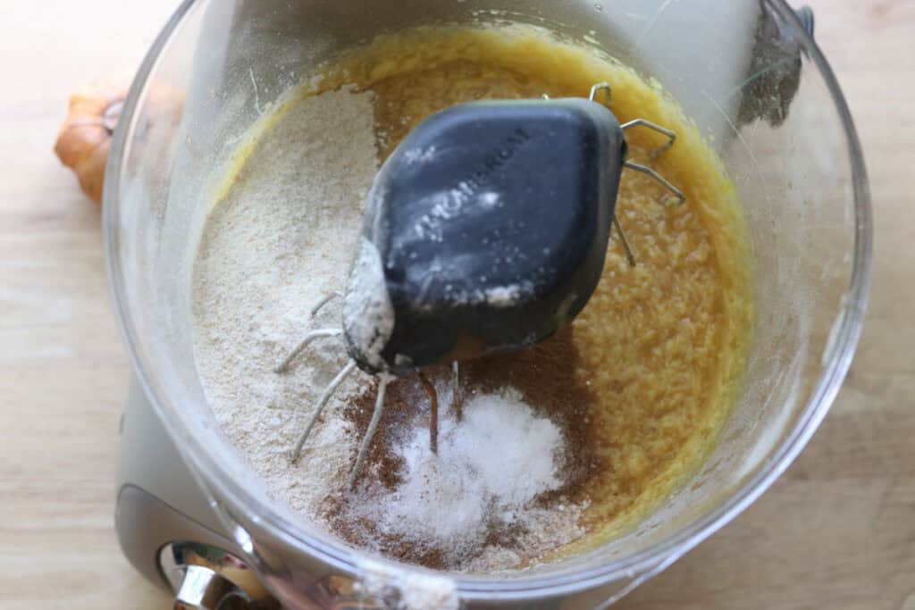 flour and cinnamon and spices in a mixing bowl to make fresh milled apple cider cupcakes