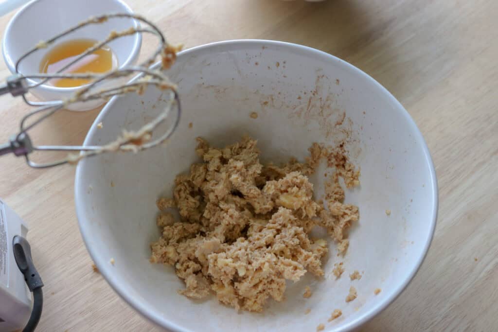 butter and spices in a mixing bowl to make buttercream for fresh milled apple cider cupcakes