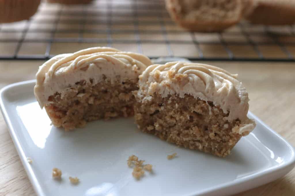 a fresh milled apple cider cupcake cut in half on a small plate