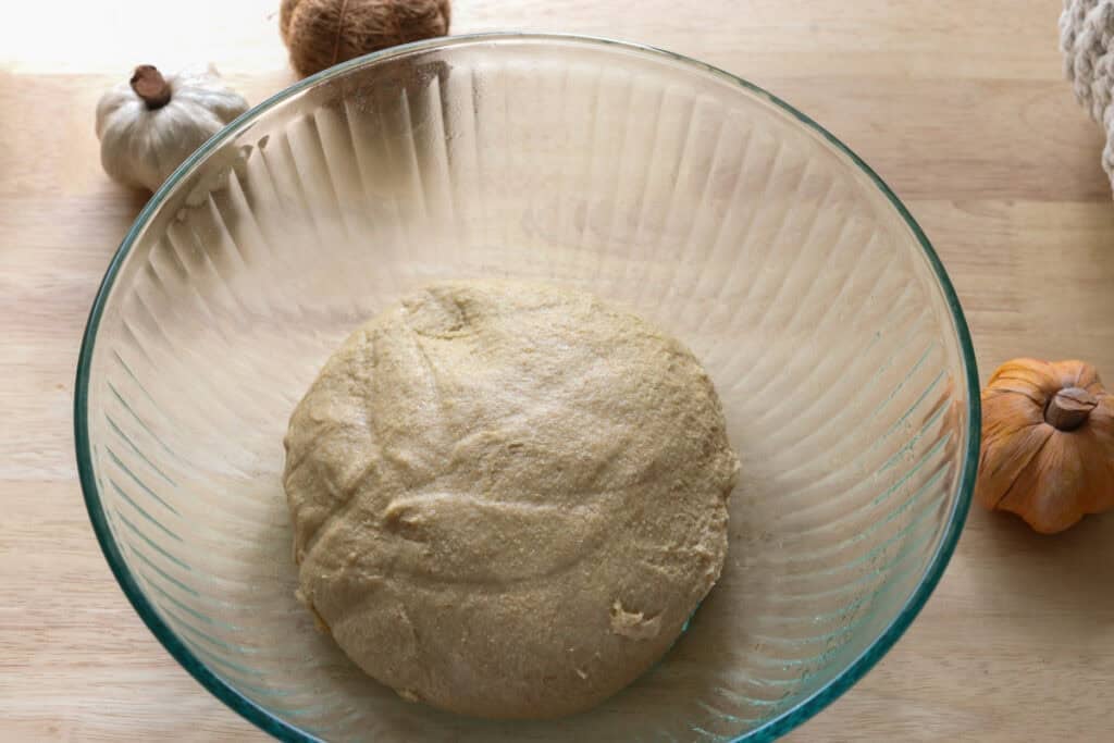  freshly milled apple cinnamon roll dough in glass bowl