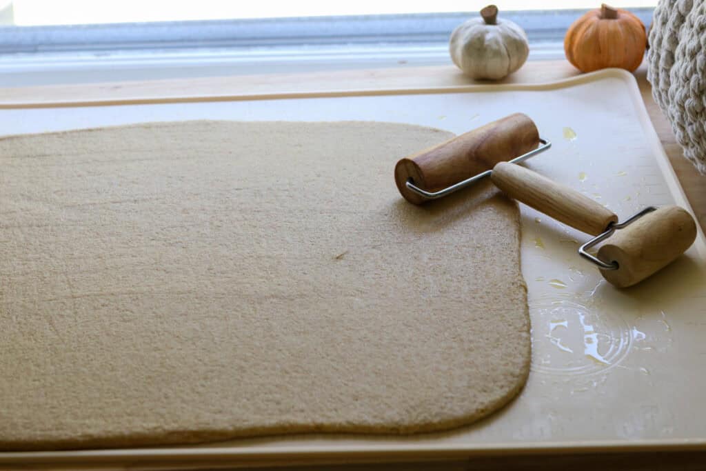  freshly milled apple cinnamon roll dough that has been rolled into a large rectangle