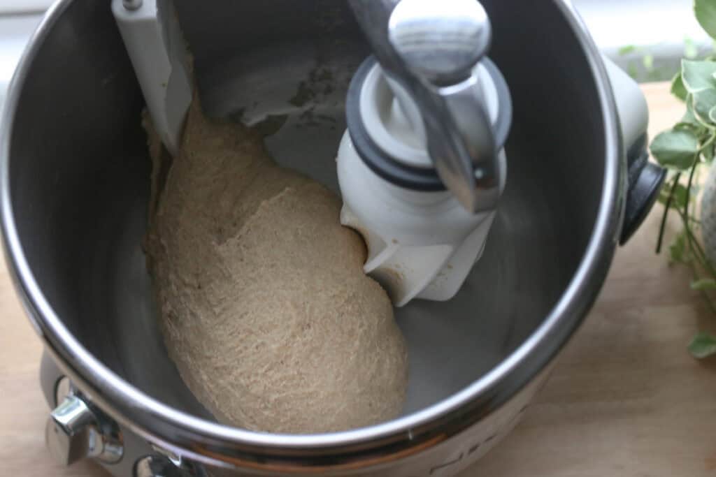 dough in a mixing bowl to make Super Soft Freshly Milled Sourdough Sandwich Bread