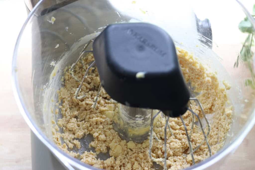 butter and maple syrup in the bowl of a stand mixer that has been creamed together to make Homemade Animal Crackers with Fresh Milled Flour