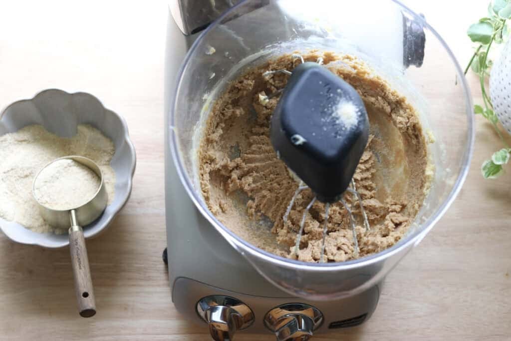 the dough for Homemade Animal Crackers with Fresh Milled Flour with a bowl of flour beside it