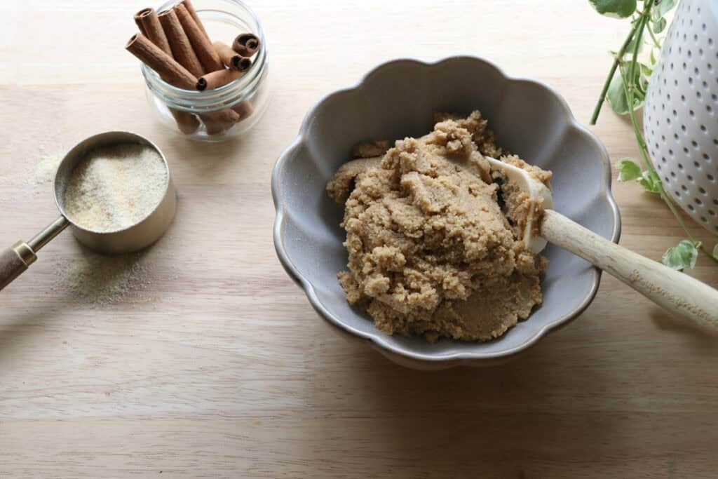 Homemade Animal Cracker dough in a bowl with flour and cinnamon sticks