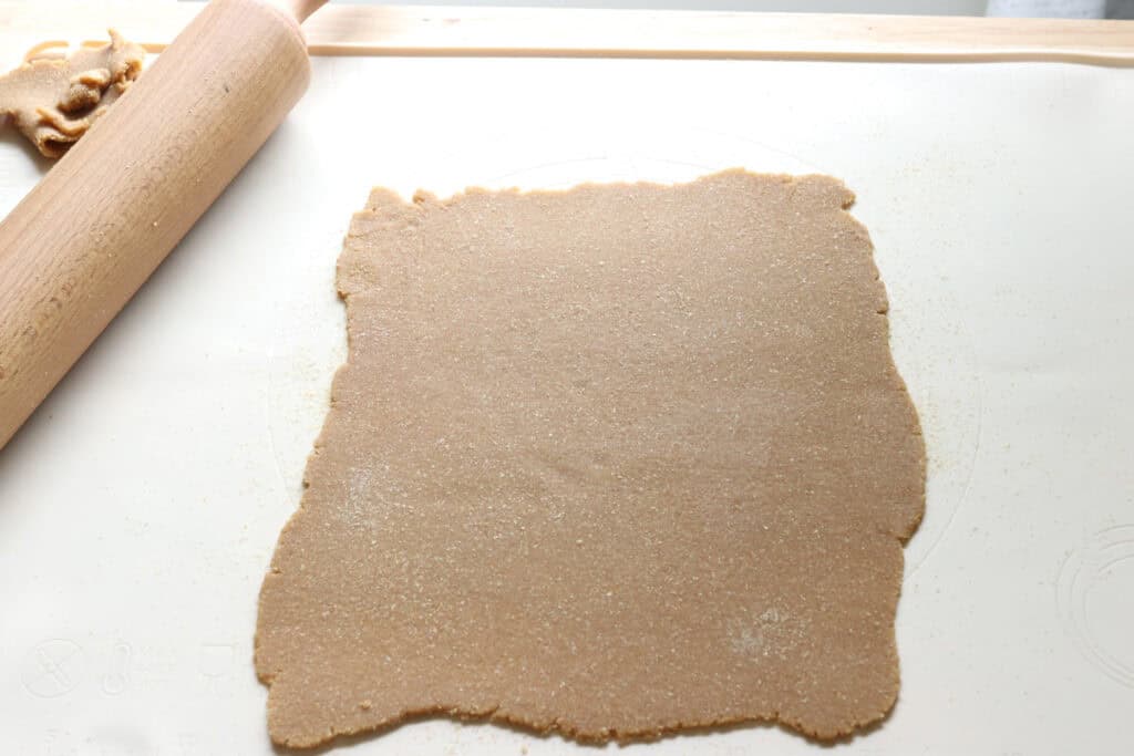 freshly milled animal cracker dough rolled out into a rectangle