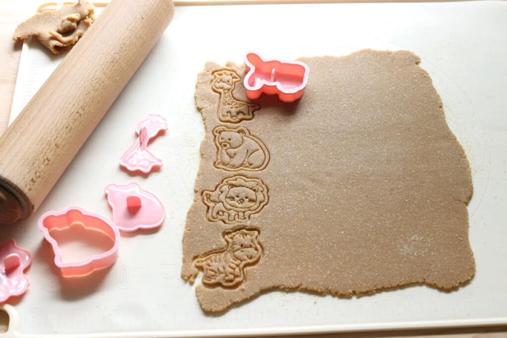 Homemade freshly milled Animal Cracker dough with animal shapes cut out