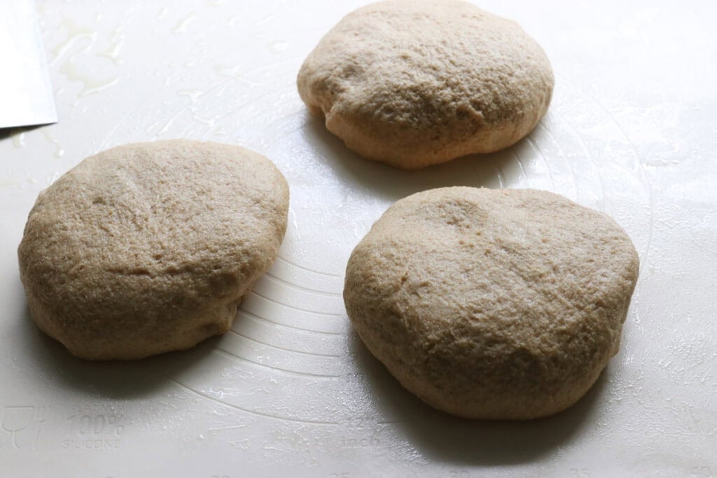 freshly milled turkey dinner roll dough divided into 3 sections