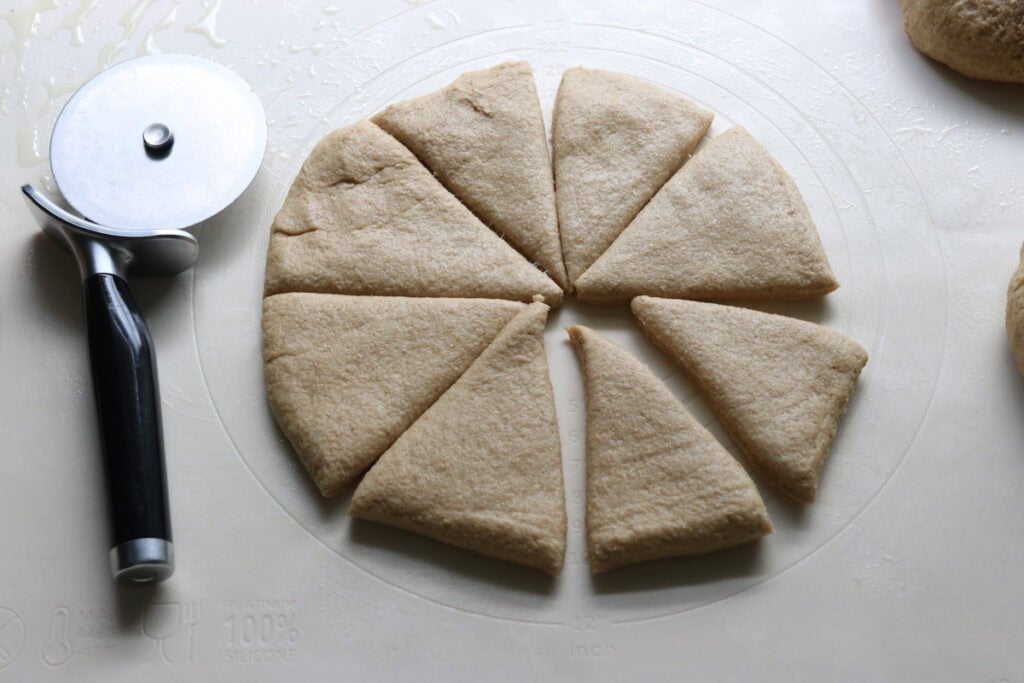 freshly milled turkey dinner roll dough divided into 8 equal triangles