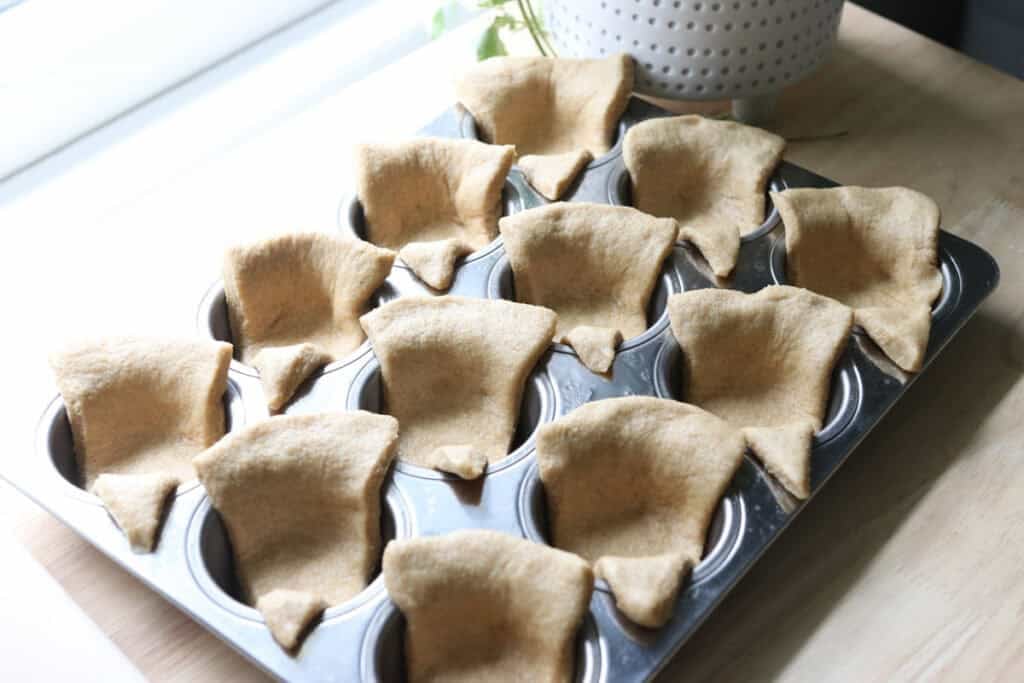 freshly milled turkey dinner roll dough pressed into a muffin pan