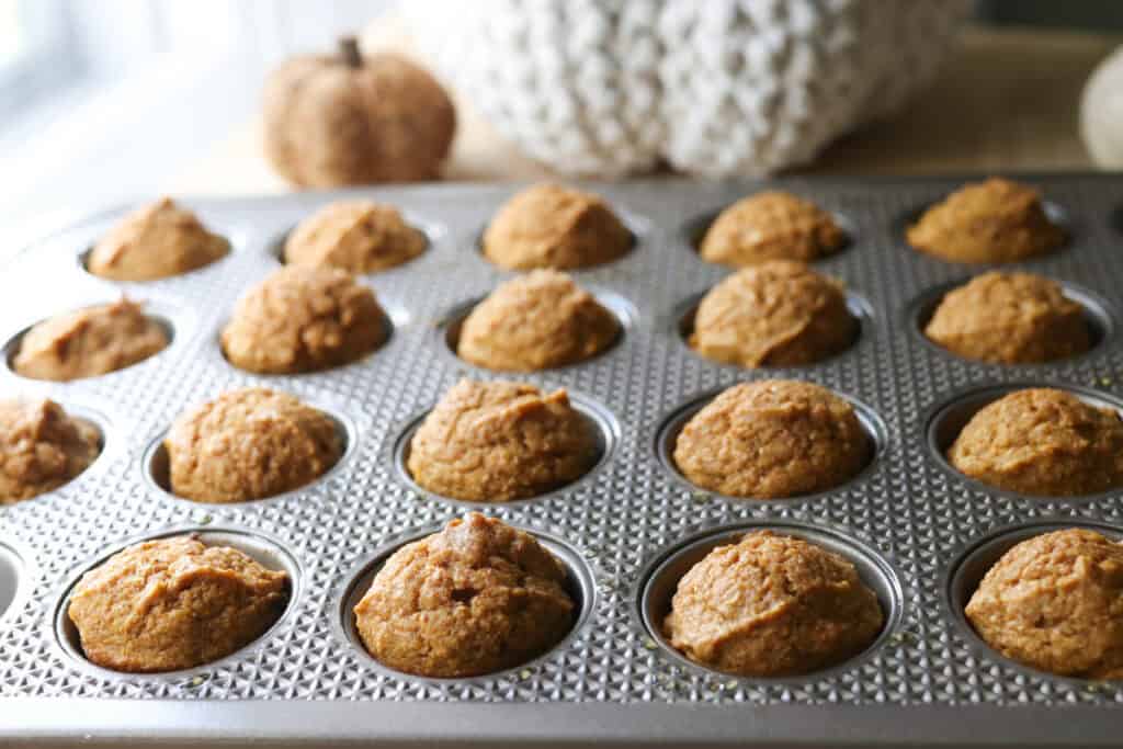 freshly milled pumpkin donuts holes in a muffin pan than have been baked
