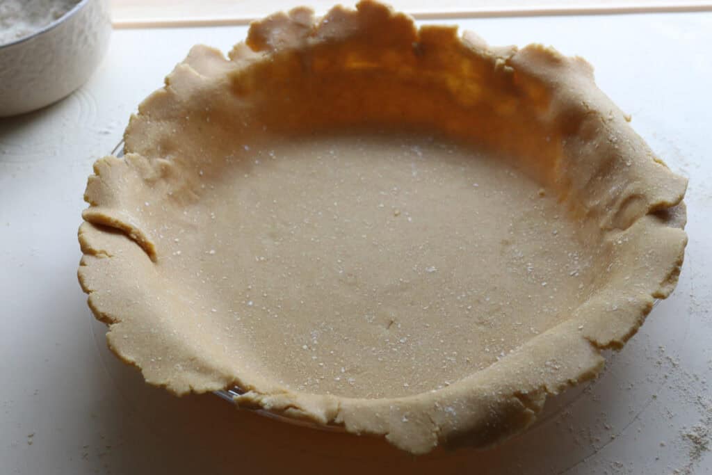 pie dough that has been placed in a pie dish for classic apple pie