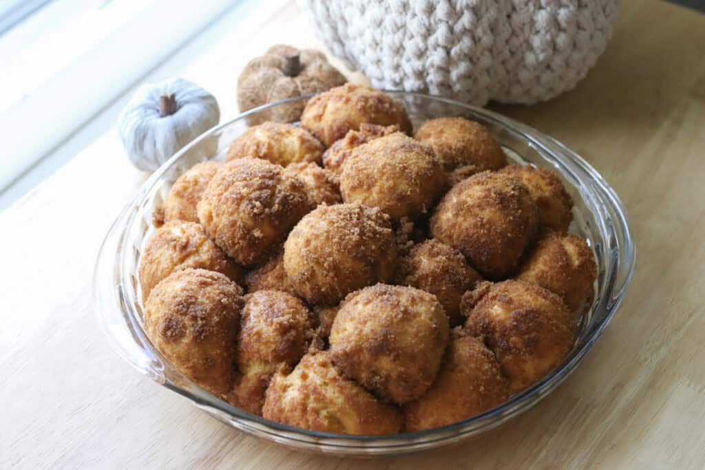 fresh milled pumpkin monkey bread that has risen until doubled in a glass pie pan
