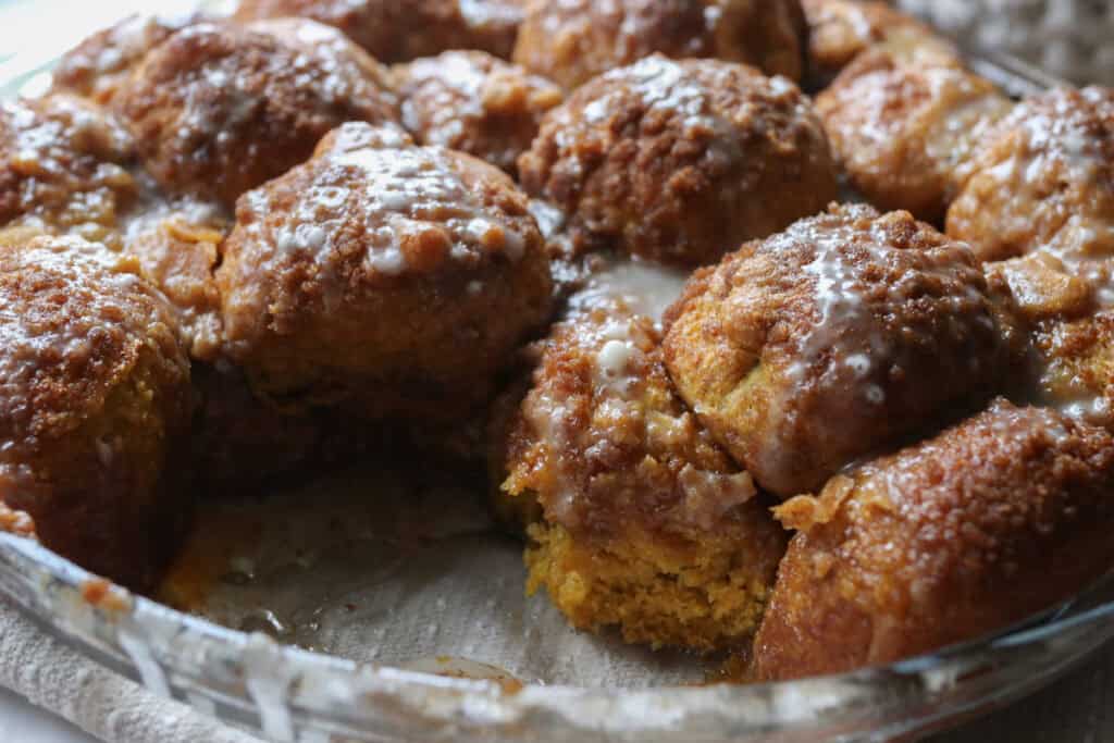 fresh milled pumpkin monkey bread  that has a piece taken out of it