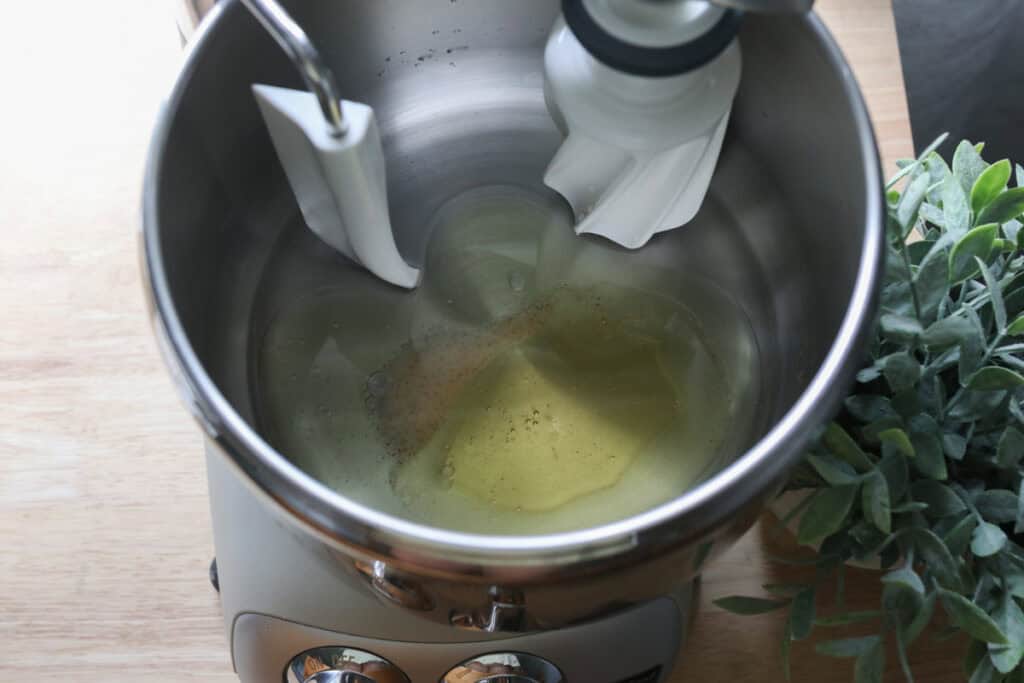 water, oil, honey, and lemon juice in a mixing bowl to make fresh milled parmesan pesto star bread
