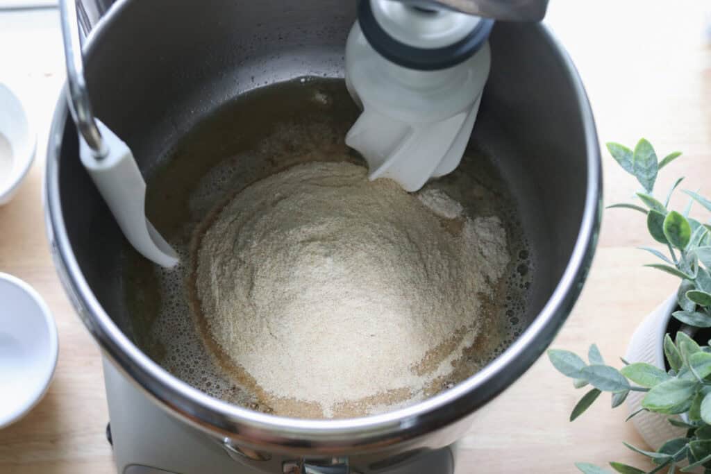 flour in a mixing bowl to make freshly milled parmesan pesto bread