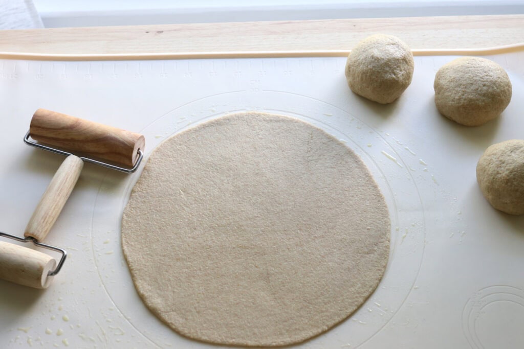 the dough for freshly milled parmesan pesto star bread rolled into a 10 inch disc