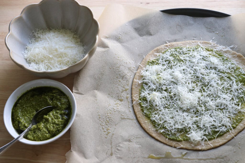 the dough for freshly milled parmesan pesto star bread rolled out and sprinkled with grated parmesan cheese