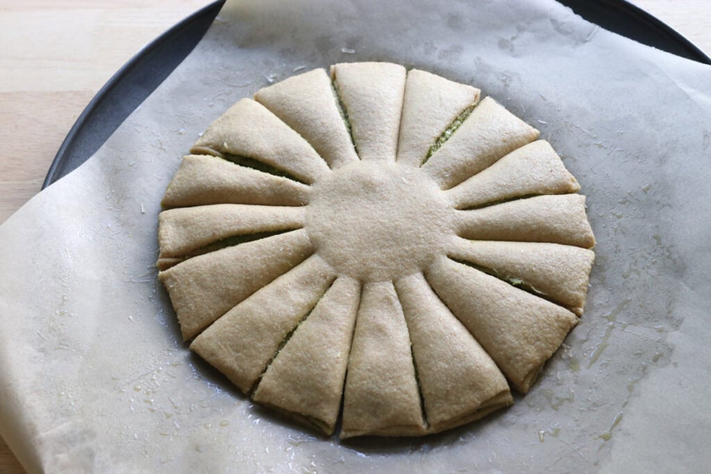 the dough for freshly milled parmesan pesto star bread cut into 16 pieces
