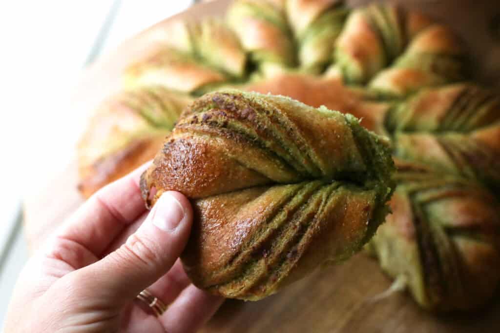 a piece of parmesan pesto star bread with fresh milled flour 