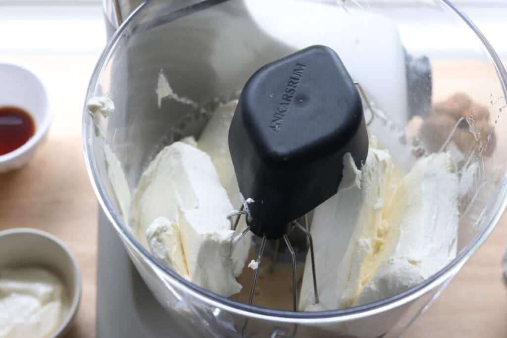softened cream cheese in a mixing bowl to make pumpkin cheesecake bars with fresh milled crust