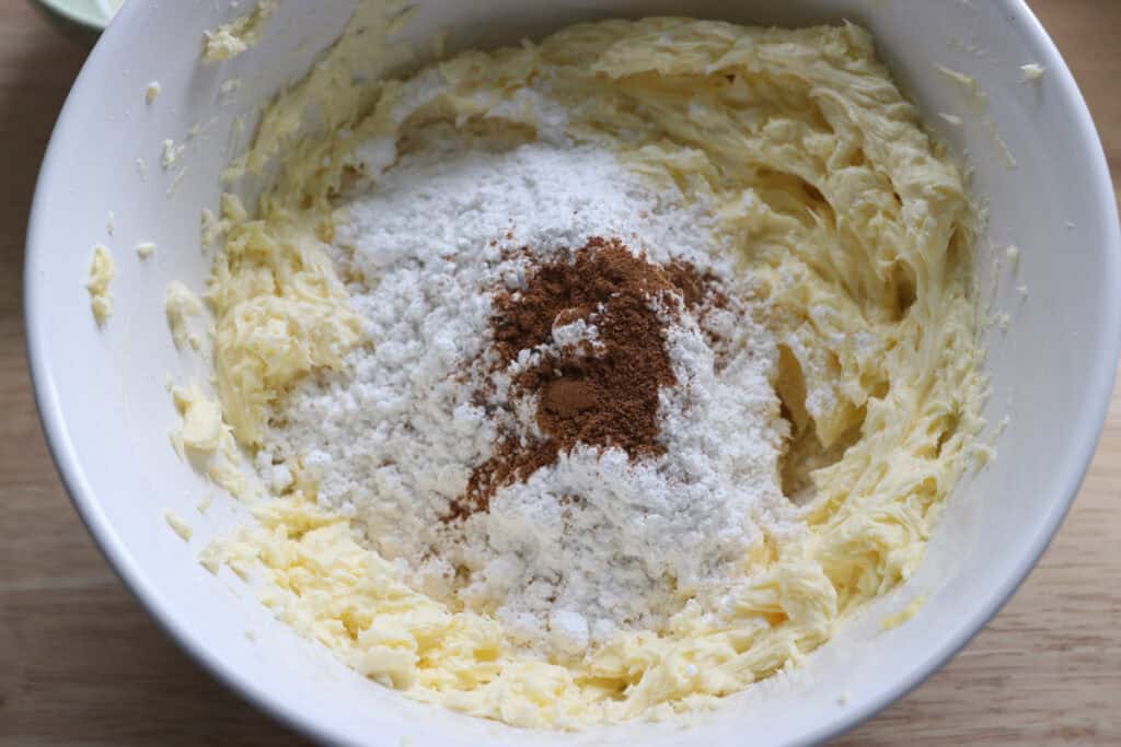 powdered sugar in a mixing bowl to make the icing for pumpkin cheesecake bars with fresh milled crust