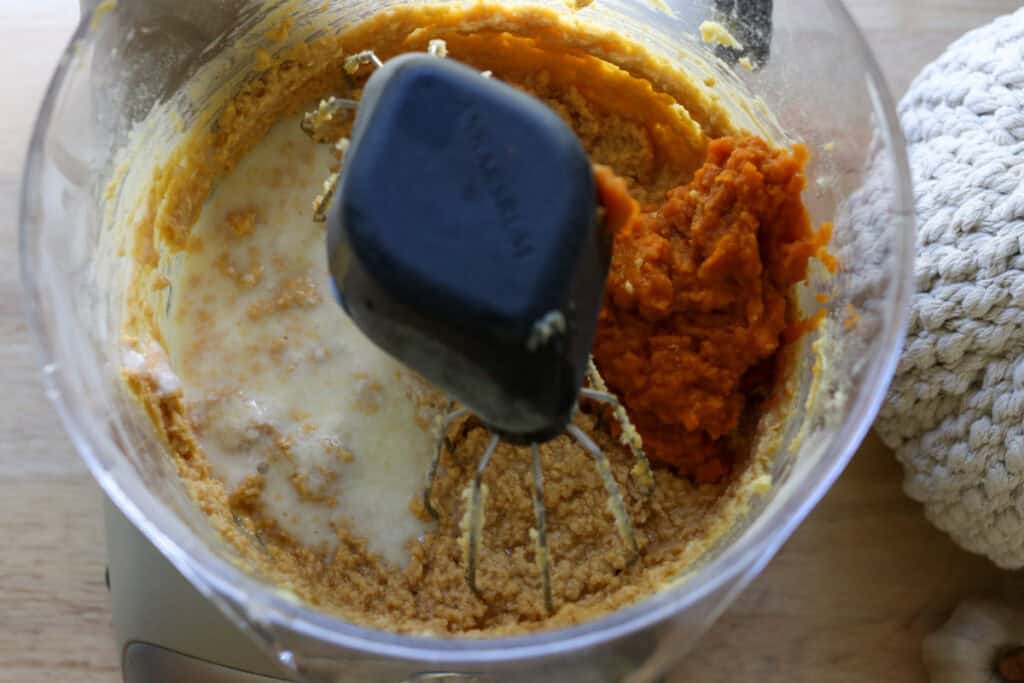 buttermilk and pumpkin puree added to a mixing bowl to make Freshly Milled Pumpkin Spice Latte Cake with Frosting