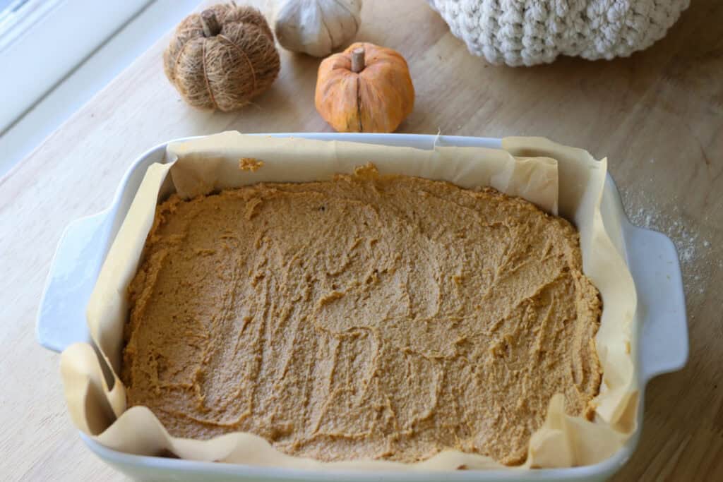 Freshly Milled Pumpkin Spice Latte Cake batter spread into a pan lined with parchment paper