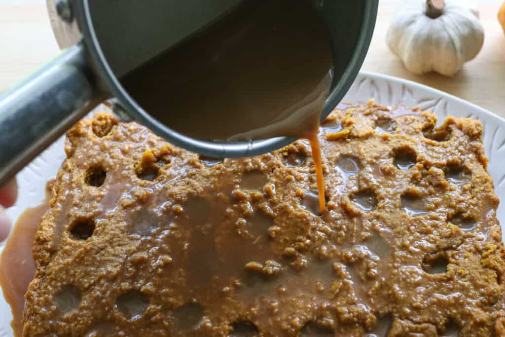 pouring the latte soak onto the freshly milled pumpkin spice latte cake