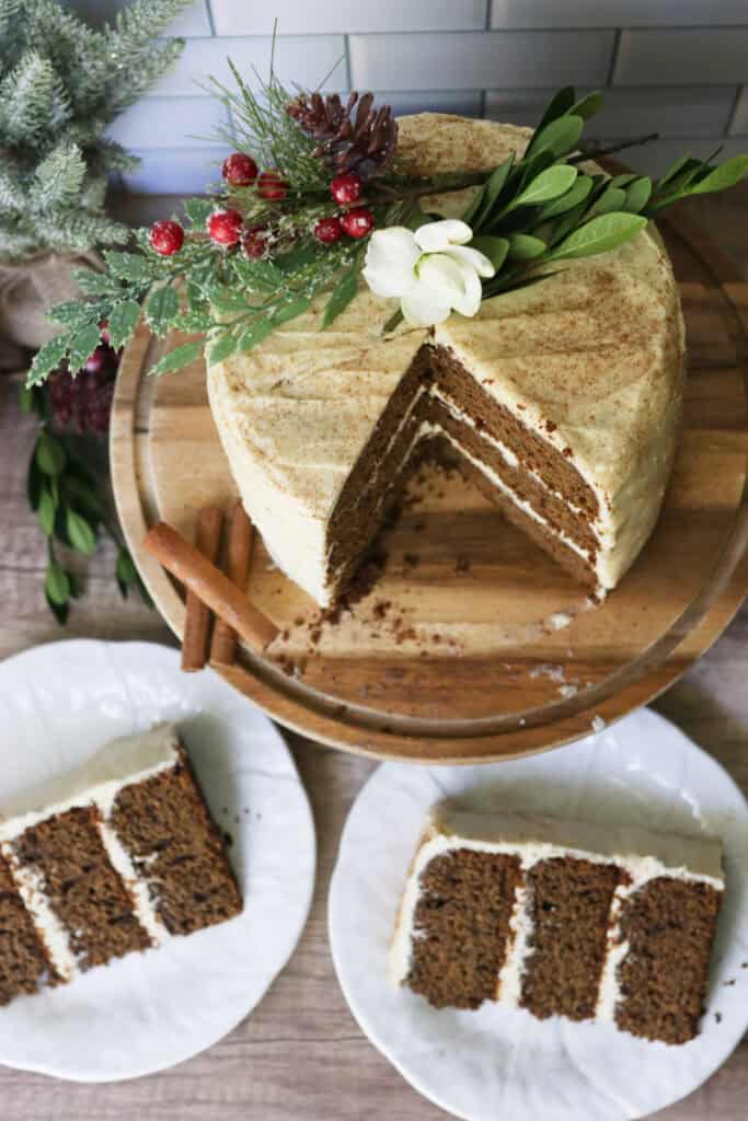 fresh milled gingerbread cake with cream cheese icing with two slices on white plates