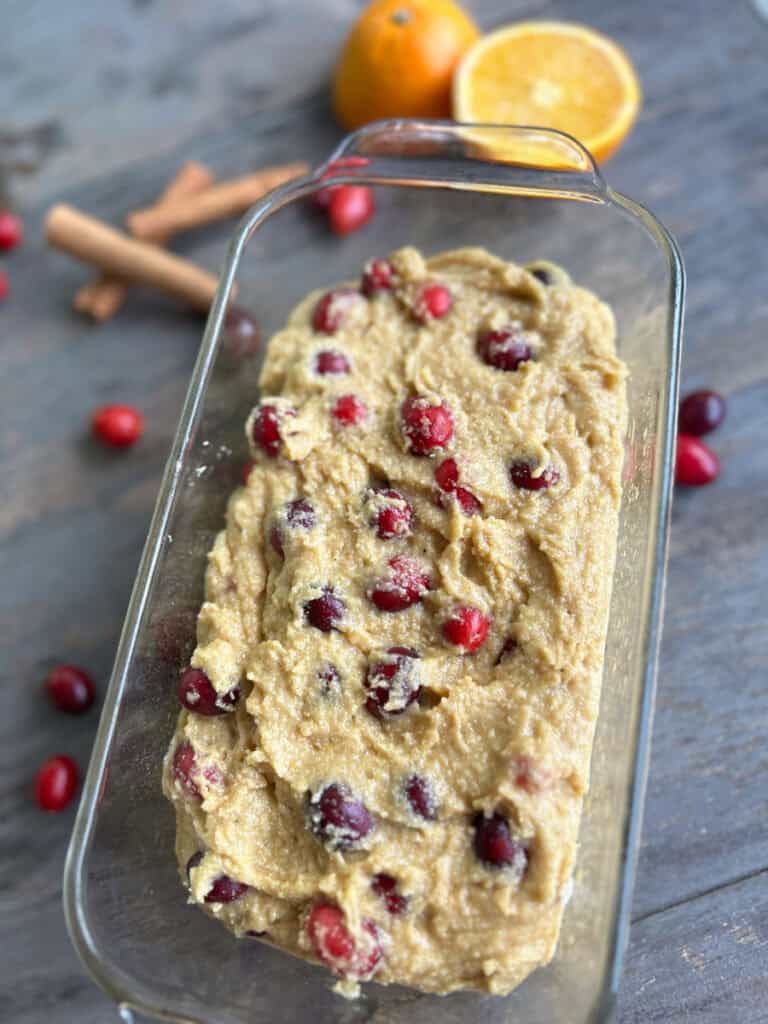 the batter for fresh milled orange cranberry loaf in a glass loaf pan