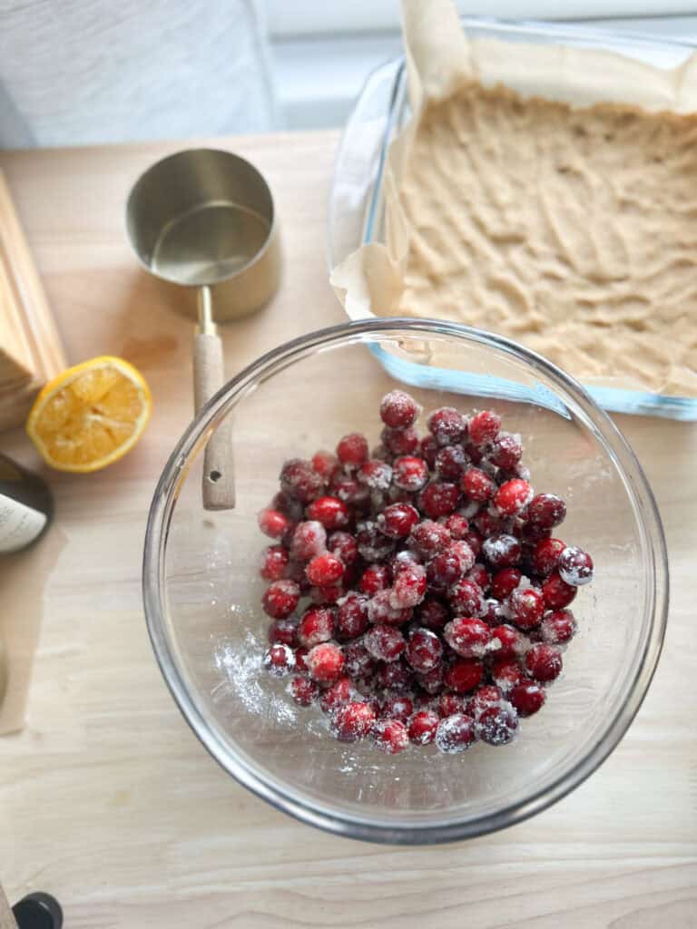cranberries tossed in sugar in a bowl to make Fresh Milled Cranberry Crumble Bars 