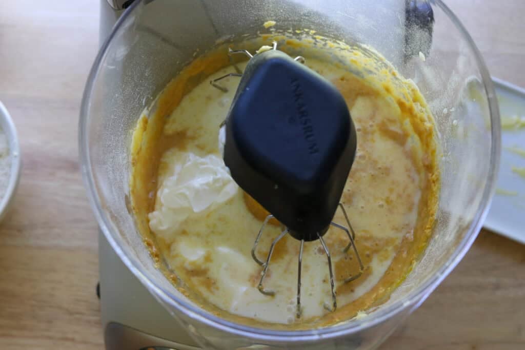 sour cream and milk added to cupcake batter to make Fresh Milled Hot Cocoa Cupcakes with Ganache Filling