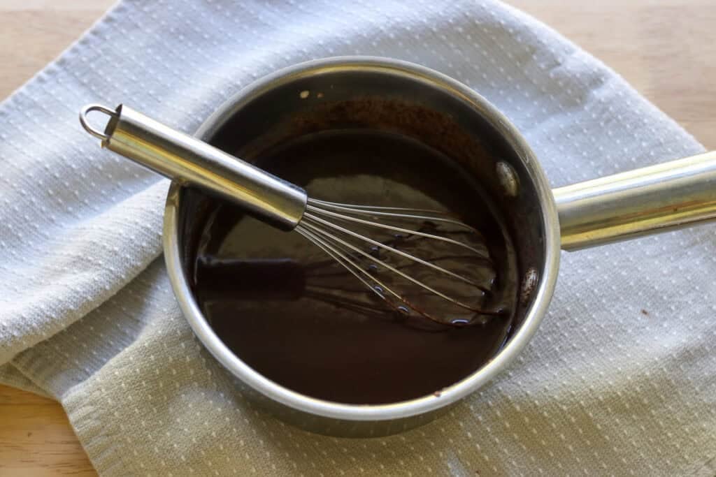 heavy cream and chocolate chips that have been melted to make the ganache for fresh milled hot cocoa cupcakes