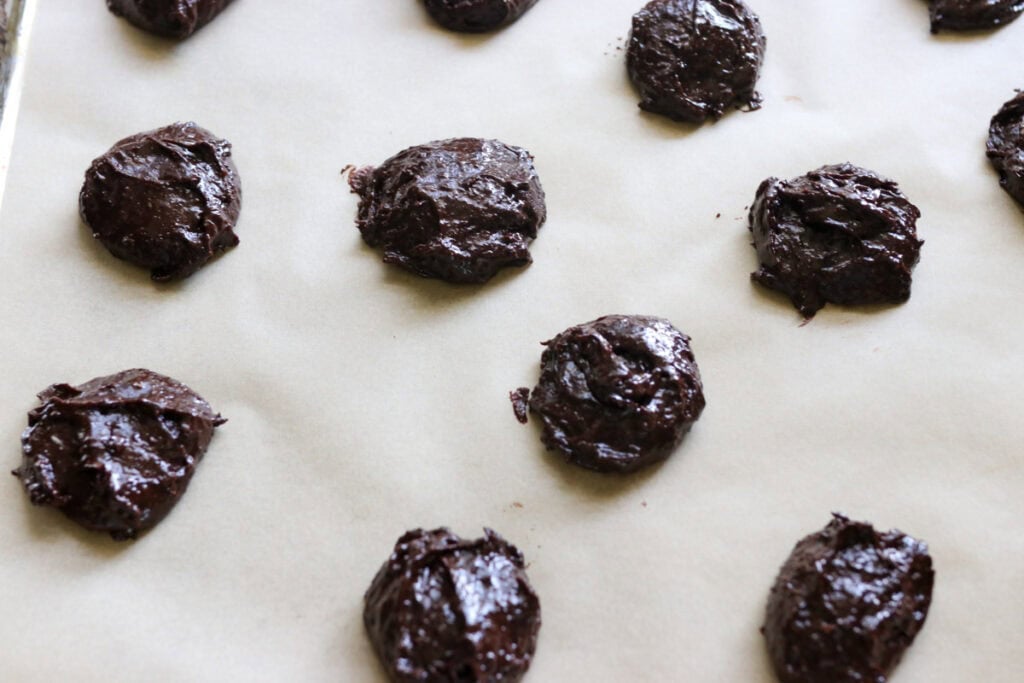 freshly milled brownie cookie batter scooped onto a baking sheet