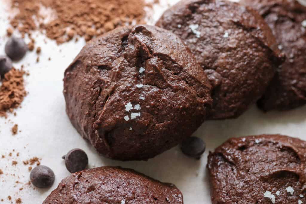 Delicious Brownie Cookies with Freshly Milled Flour and cocoa powder on white parchment paper