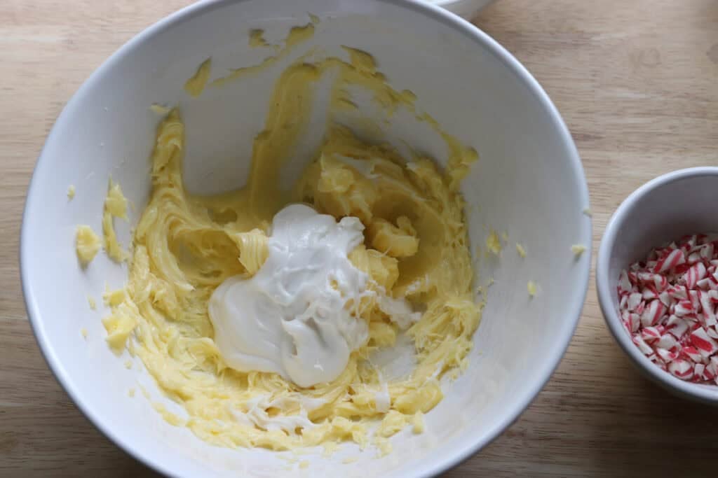white chocolate and butter in a mixing bowl to make the buttercream for Freshly Milled White Chocolate Peppermint Cupcakes