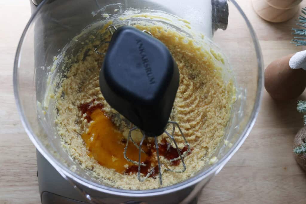 egg yolk and vanilla in a mixing bowl to make fresh milled healthy christmas sugar cookie dough