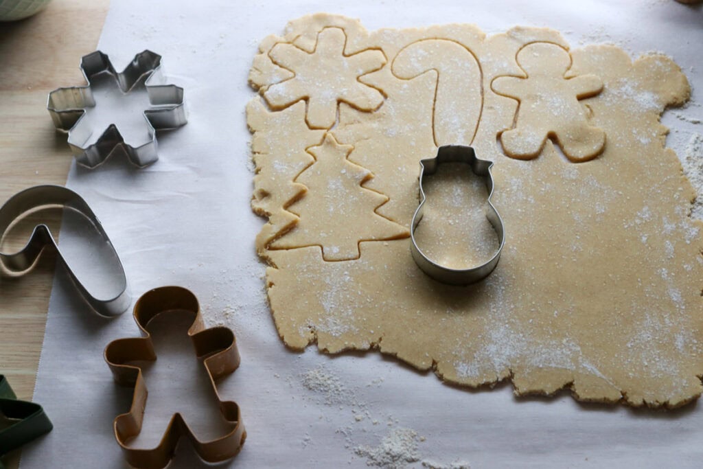fresh milled sugar cookie dough that has been rolled out and cut into shapes