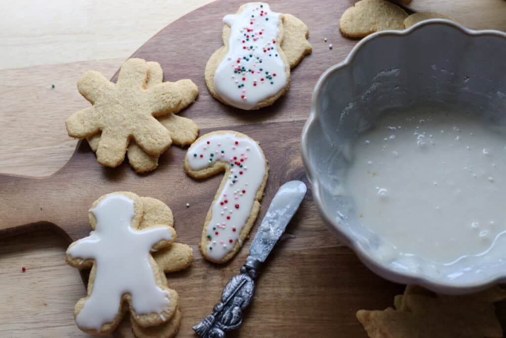 The Best Fresh Milled Healthy Christmas Sugar Cookies and a bowl of icing beside it