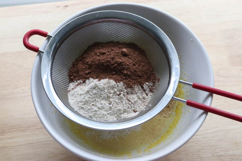 flour and cocoa powder that have been sifted to make  freshly milled chocolate yule log cake