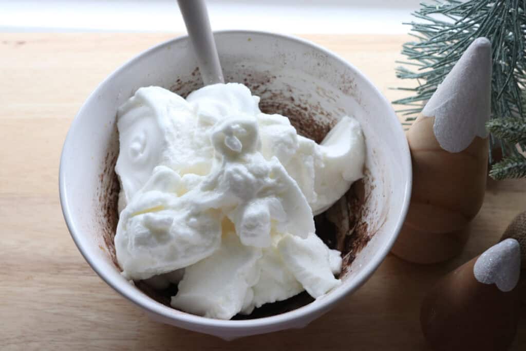 egg whites in a white bowl to make  freshly milled chocolate yule log cake